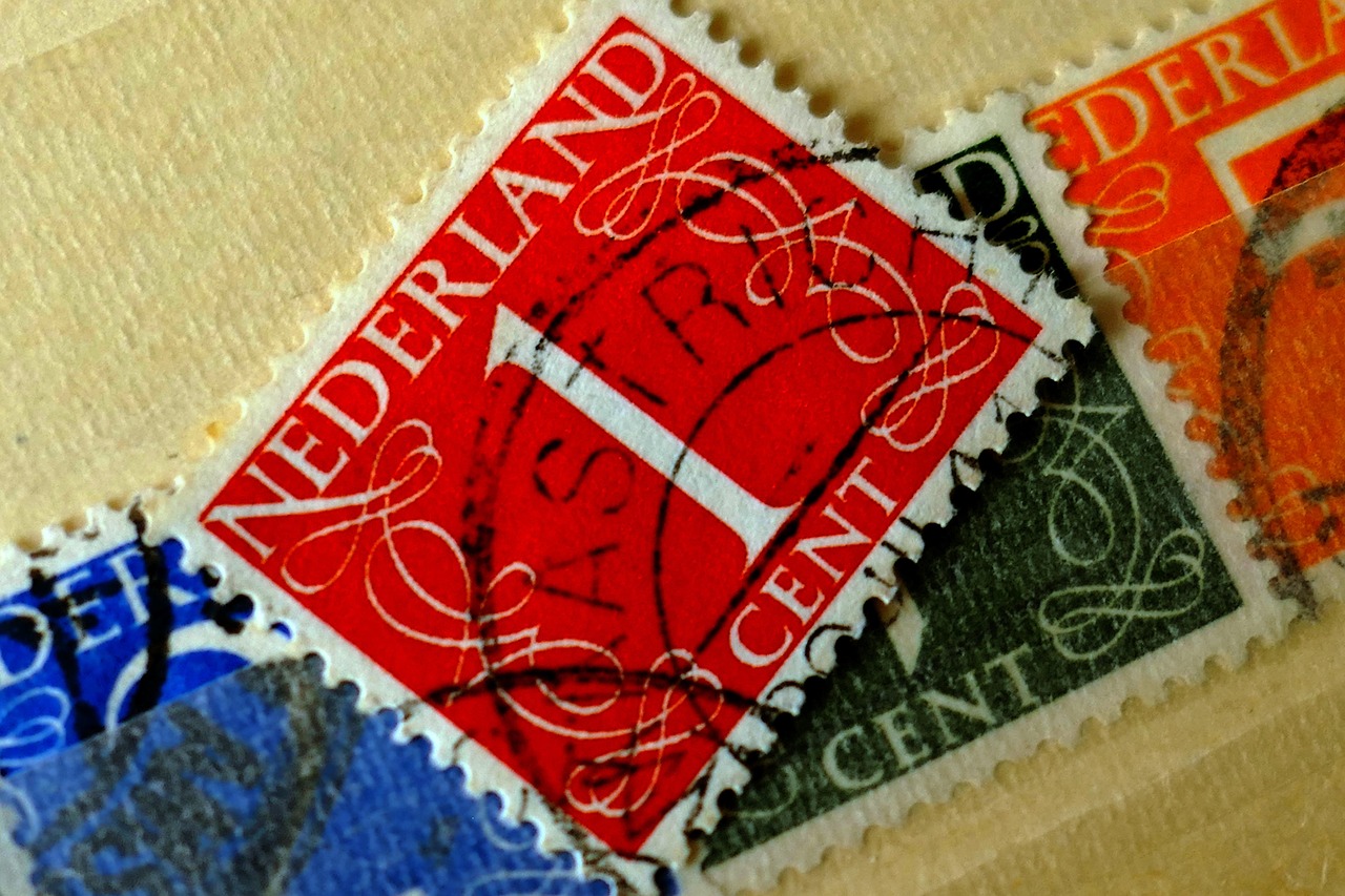 Francobolli rari in una collezione, alcuni esemplari con valore elevato, su un tavolo di legno.